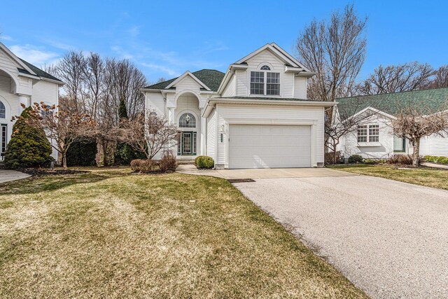 traditional-style home featuring driveway, a front lawn, and a garage