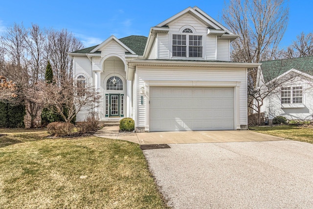 traditional-style home with driveway, an attached garage, and a front yard