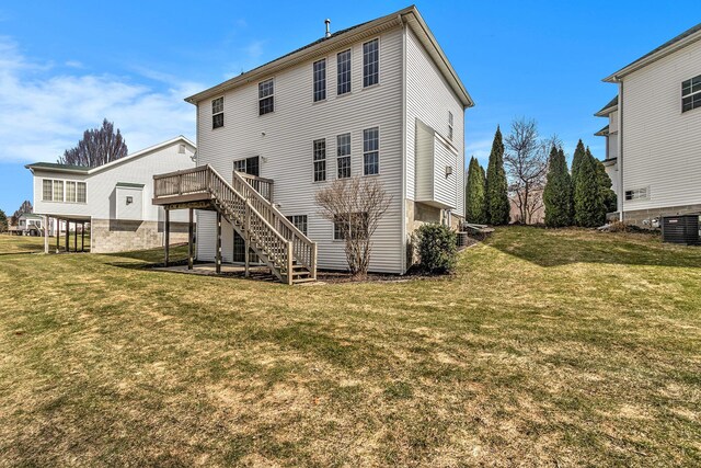 rear view of property featuring stairs, a deck, central air condition unit, and a lawn