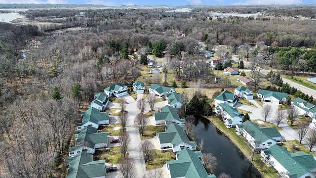 birds eye view of property with a forest view, a residential view, and a water view