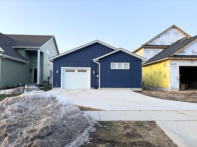 view of front facade featuring an attached garage, board and batten siding, and driveway