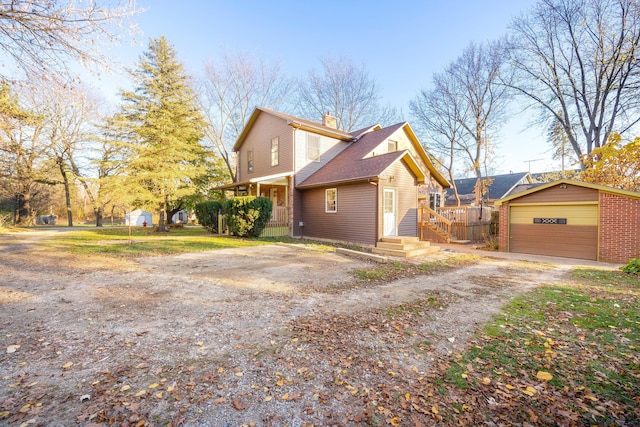 view of home's exterior with a garage and an outdoor structure