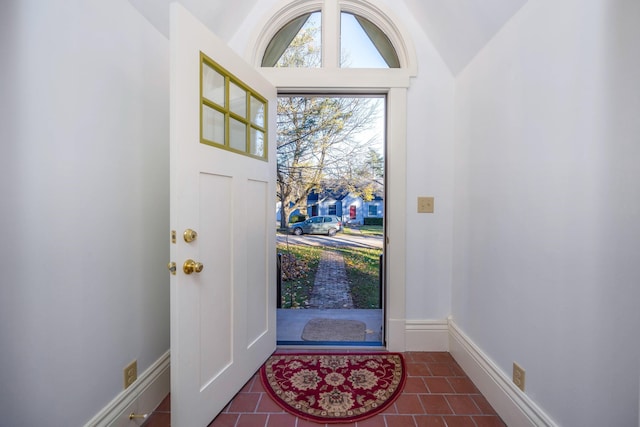 tiled foyer entrance with vaulted ceiling