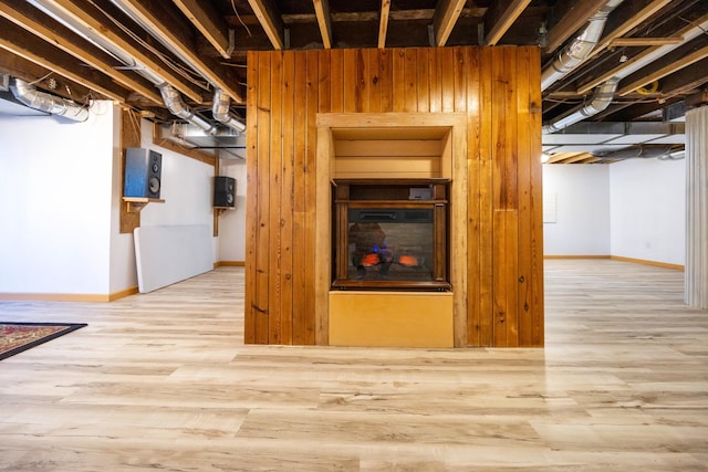 basement with light hardwood / wood-style floors