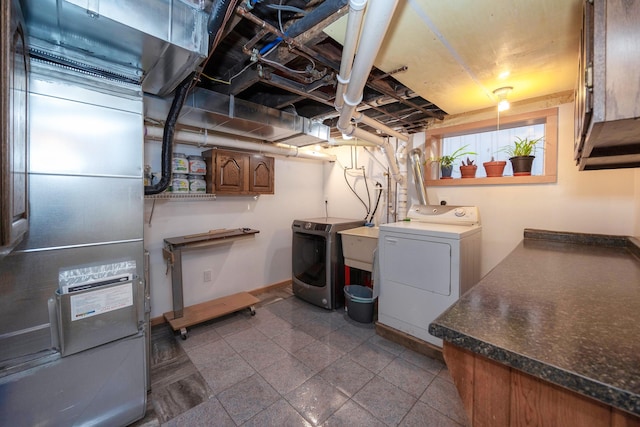 washroom with separate washer and dryer and cabinets