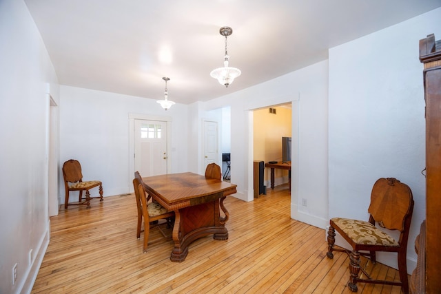 dining space with light hardwood / wood-style flooring