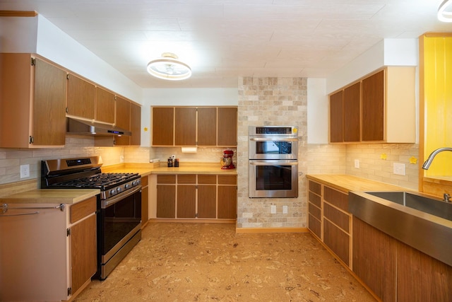 kitchen featuring decorative backsplash and appliances with stainless steel finishes