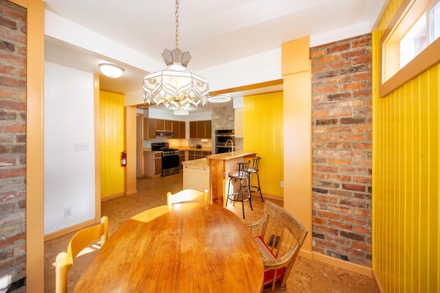 dining space with brick wall