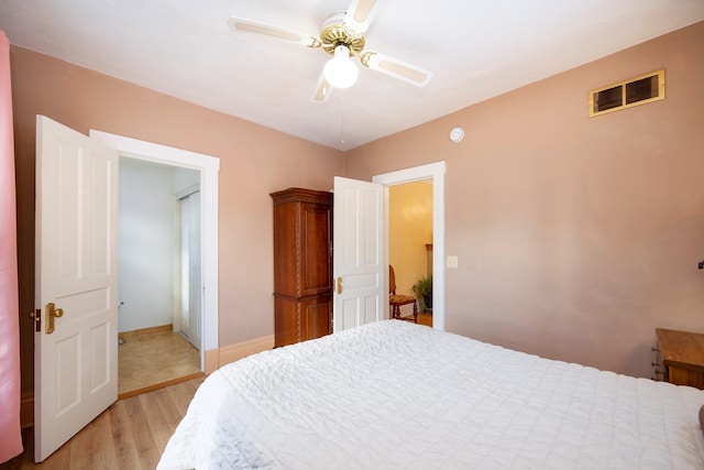 bedroom with ceiling fan and light wood-type flooring