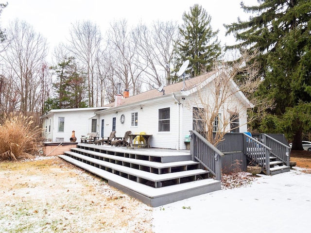 rear view of house featuring a wooden deck