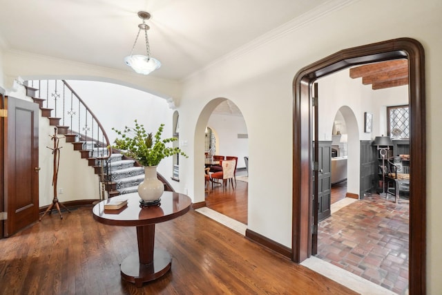 foyer entrance with hardwood / wood-style flooring and crown molding