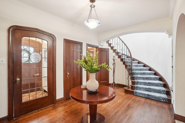 foyer featuring crown molding and hardwood / wood-style floors