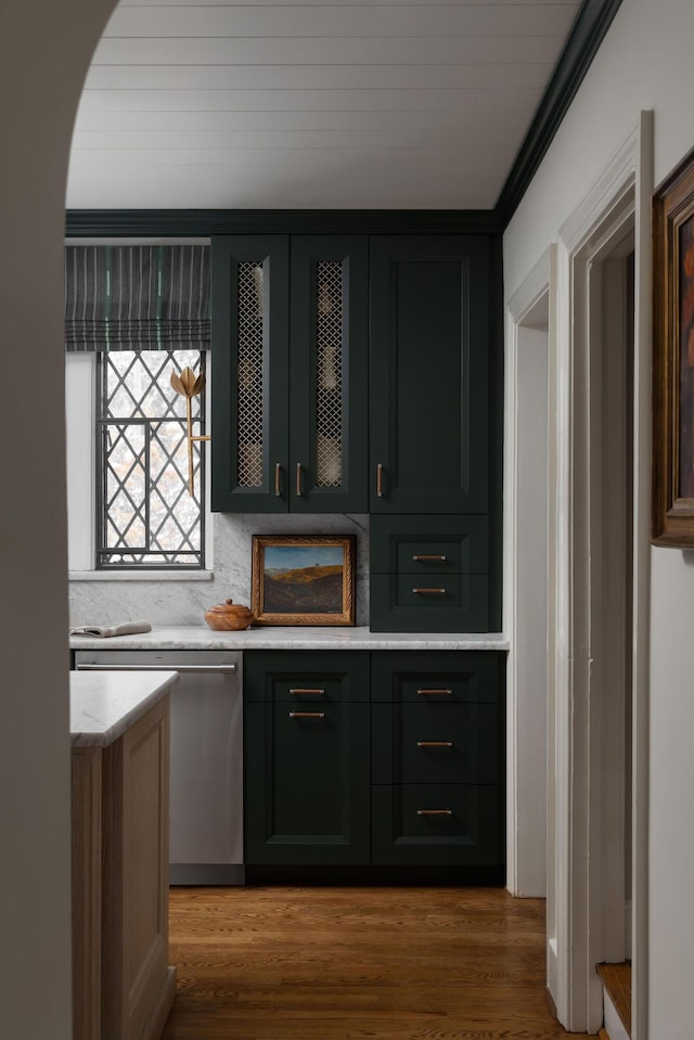 bar featuring crown molding, wood finished floors, and dishwasher