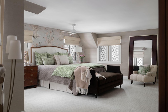 carpeted bedroom with baseboards and wallpapered walls