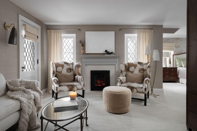 carpeted living room with baseboards and a brick fireplace
