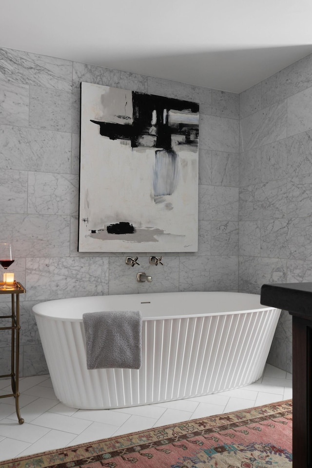 bathroom featuring tile patterned floors, tile walls, and a freestanding tub