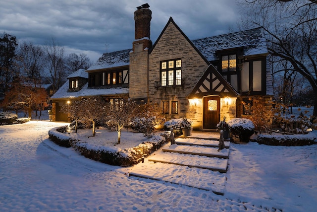 view of front of home with a chimney and stone siding