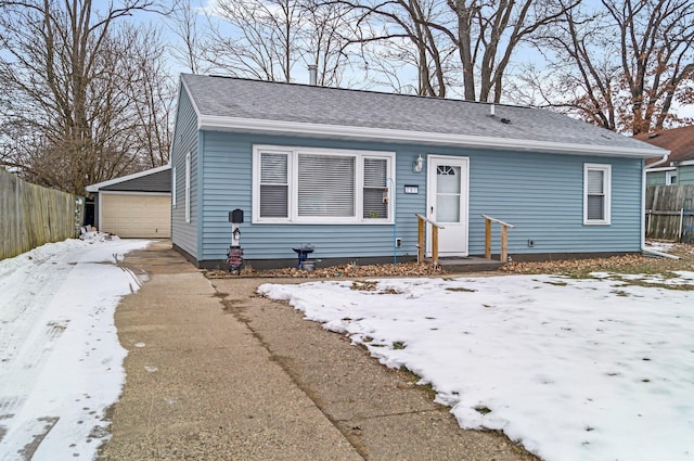 view of front of home with a garage and an outdoor structure