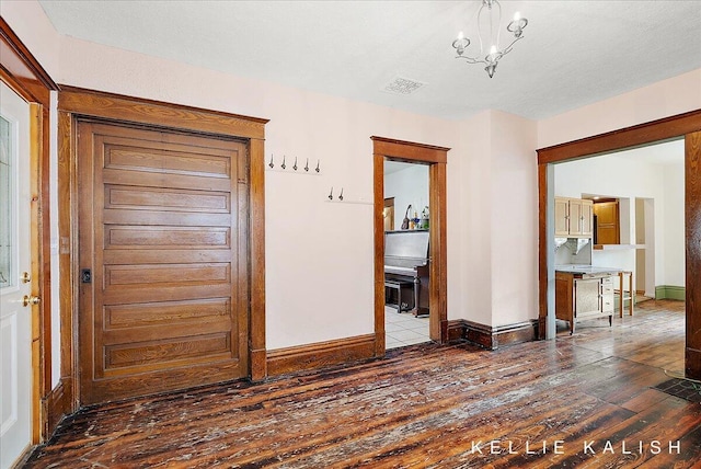 324 Gunnison Ave SW, Grand Rapids, MI 49504 - foyer entrance featuring dark wood-type flooring and a chandelier