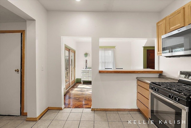 324 Gunnison Ave SW, Grand Rapids, MI 49504 - kitchen with stainless steel appliances, light brown cabinetry, and light tile patterned flooring