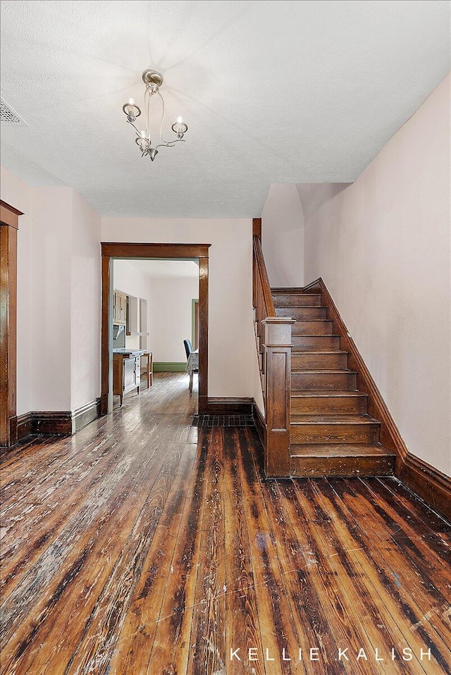 324 Gunnison Ave SW, Grand Rapids, MI 49504 - stairway with hardwood / wood-style flooring and a chandelier