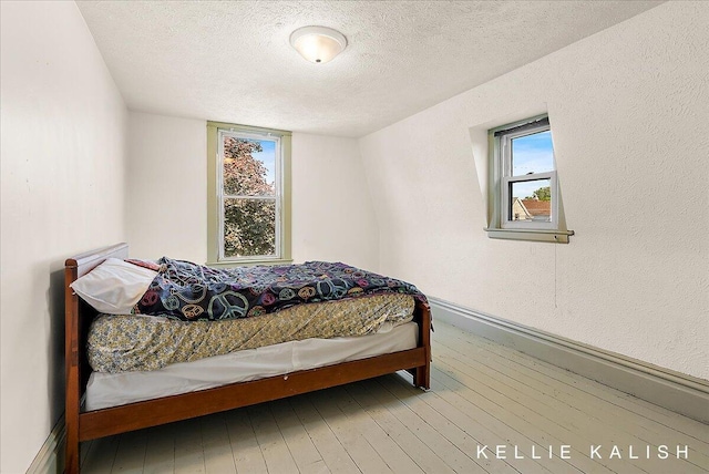 324 Gunnison Ave SW, Grand Rapids, MI 49504 - bedroom featuring wood-type flooring and a textured ceiling