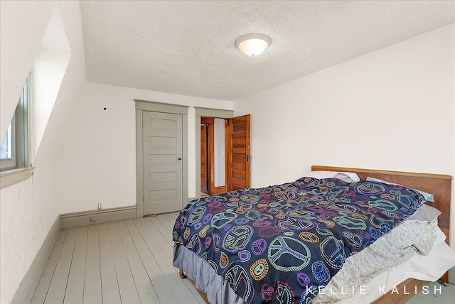 324 Gunnison Ave SW, Grand Rapids, MI 49504 - bedroom featuring a textured ceiling and wood-type flooring