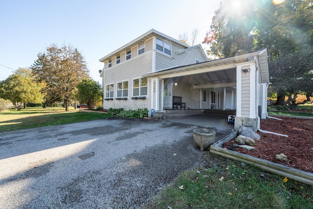 view of front of property with a carport and a front yard