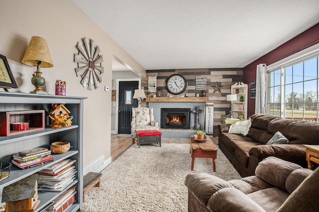 living room with a brick fireplace, baseboards, and visible vents