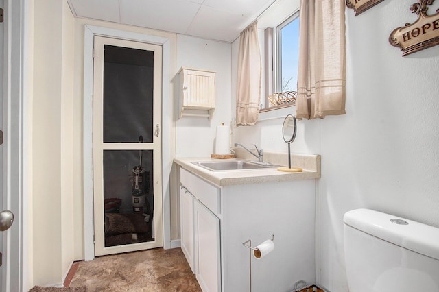 half bath featuring vanity and toilet