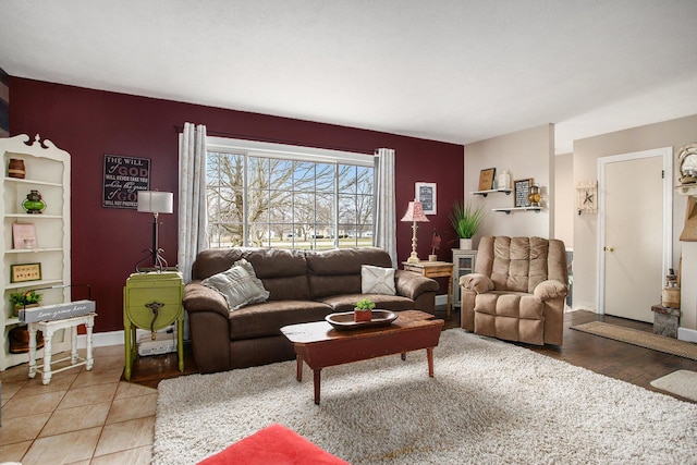 living room featuring tile patterned floors and baseboards