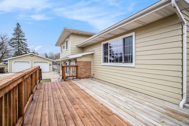 wooden deck featuring a detached garage and an outdoor structure