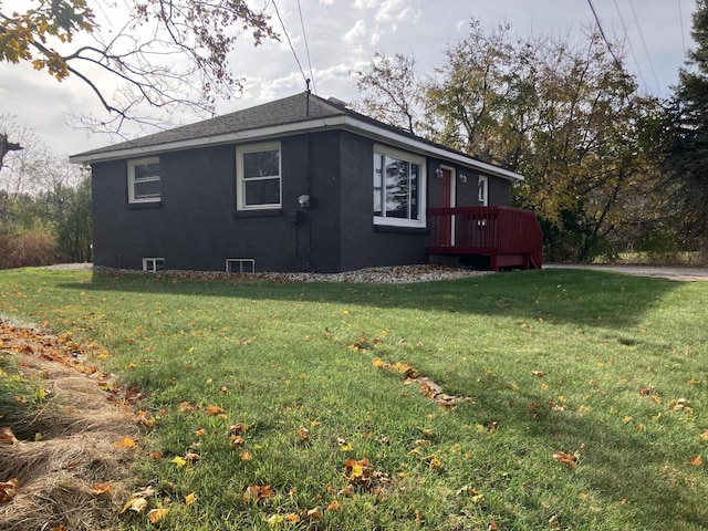 view of side of property featuring a deck and a lawn