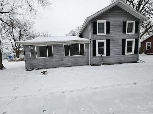 view of snow covered rear of property