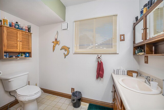 12118 N Sherman Lake Dr, Augusta, MI 49012 - half bath with vanity, toilet, baseboards, and tile patterned flooring