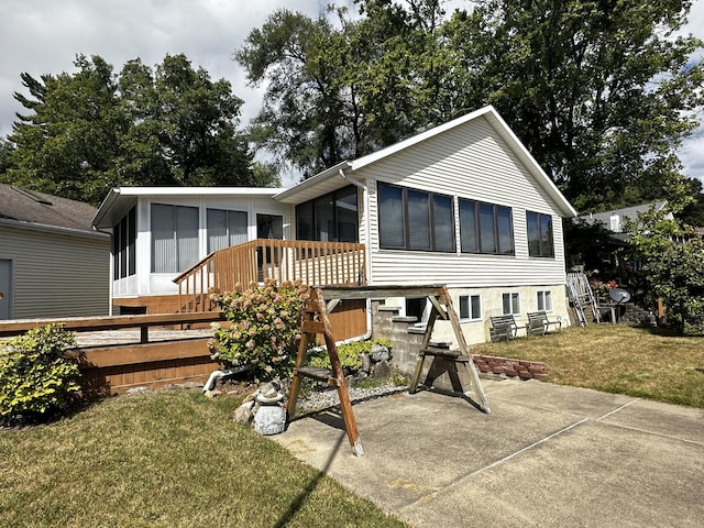 12118 N Sherman Lake Dr, Augusta, MI 49012 - rear view of house featuring a patio area, stairway, a lawn, and a sunroom