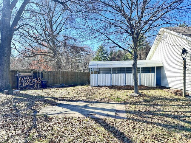 12118 N Sherman Lake Dr, Augusta, MI 49012 - view of yard featuring fence and a sunroom