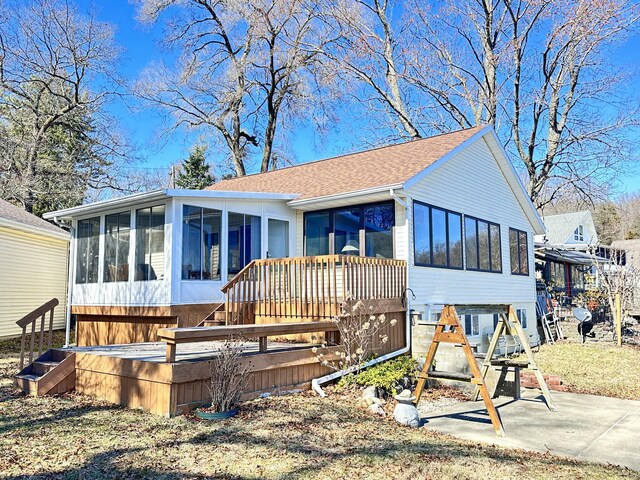 12118 N Sherman Lake Dr, Augusta, MI 49012 - view of front facade featuring a sunroom and roof with shingles