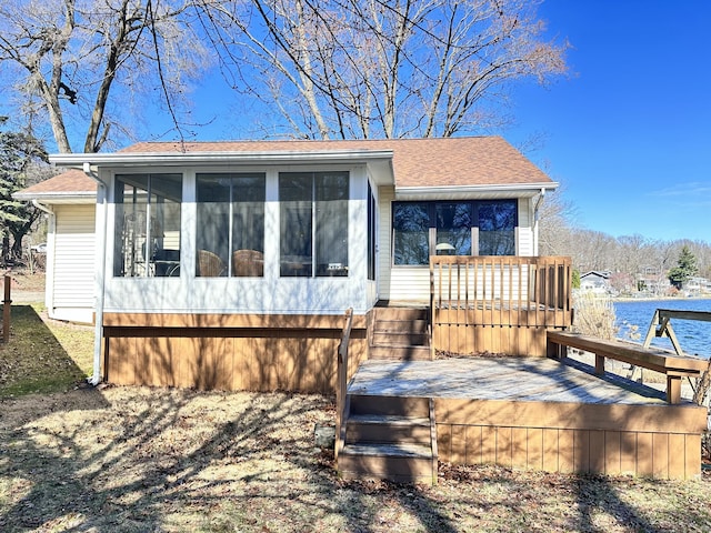 12118 N Sherman Lake Dr, Augusta, MI 49012 - view of front of house with a shingled roof, a deck, and a sunroom