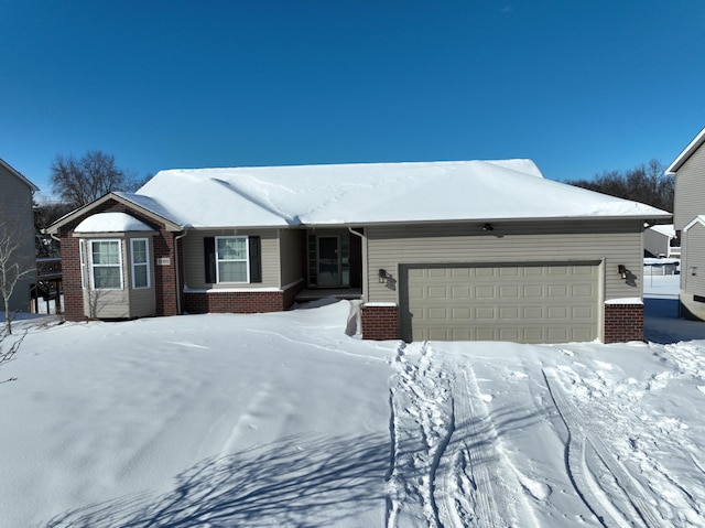 ranch-style house with a garage and brick siding