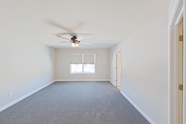 carpeted empty room featuring ceiling fan and baseboards