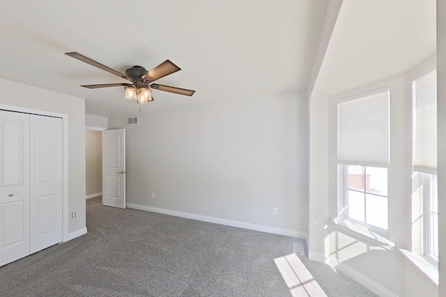 unfurnished bedroom featuring carpet, a closet, visible vents, and baseboards