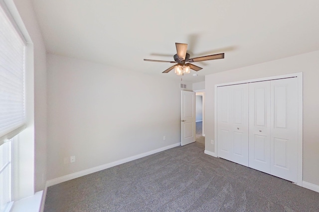 unfurnished bedroom featuring visible vents, baseboards, a ceiling fan, carpet floors, and a closet