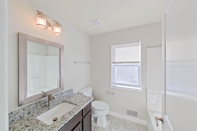 bathroom with toilet, baseboards, a tub to relax in, and visible vents