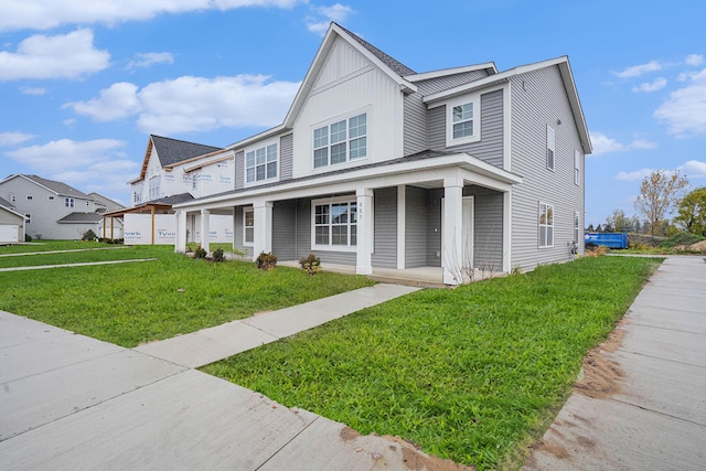 view of front of house with a front yard and covered porch