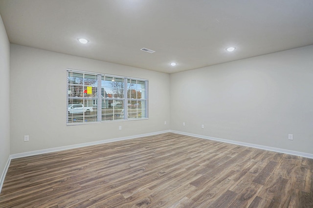 empty room featuring dark hardwood / wood-style flooring