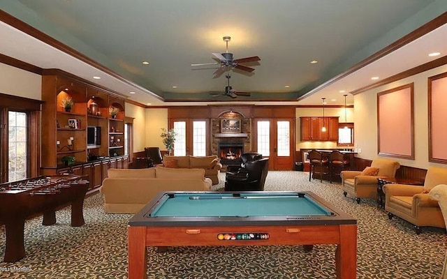 recreation room with billiards, carpet flooring, ceiling fan, a raised ceiling, and crown molding