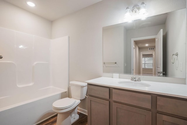 full bathroom with vanity, toilet, hardwood / wood-style floors, and shower / bathing tub combination