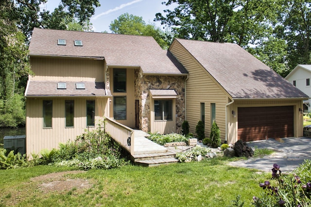 view of front of property with a garage and a front lawn