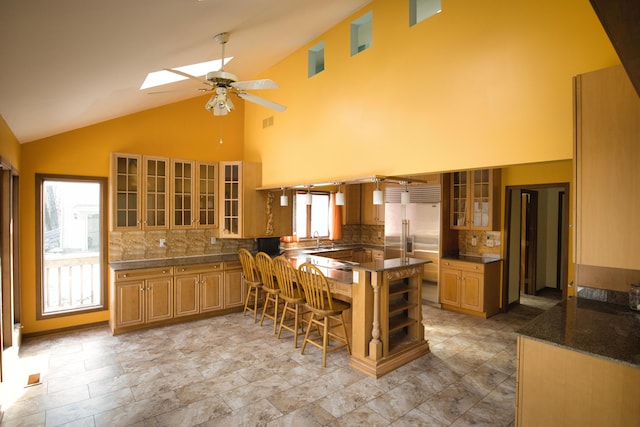 10773 Frankfort, Pinckney, MI 48169 - kitchen with a breakfast bar, a skylight, stainless steel built in fridge, kitchen peninsula, and ceiling fan